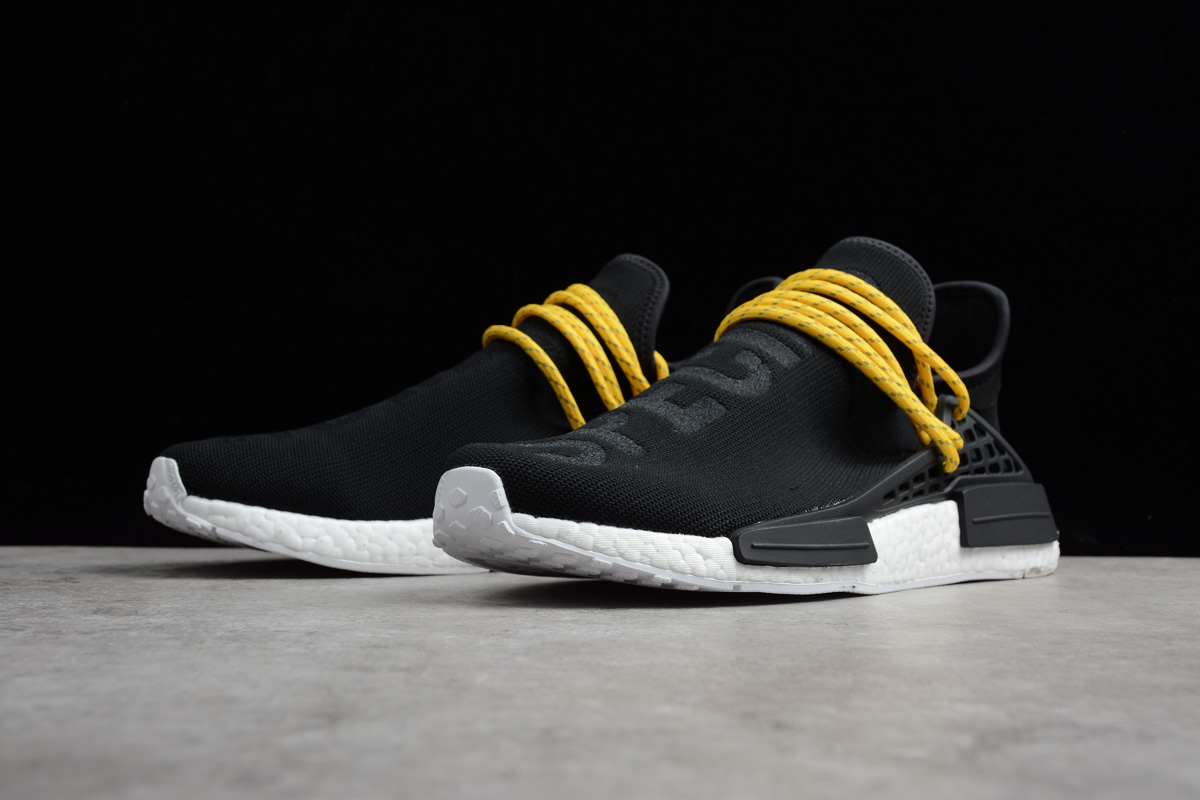black and yellow human race shoes