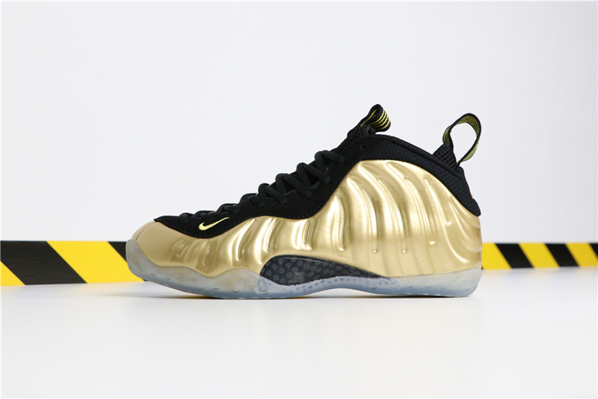 all black foams with gold nike sign